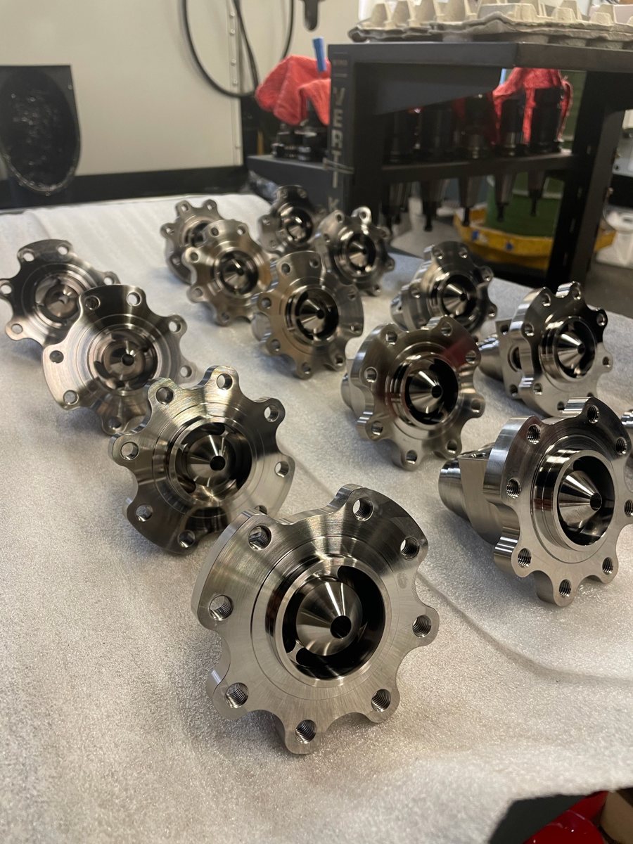 Group of machined stainless flanged housings with conical bores