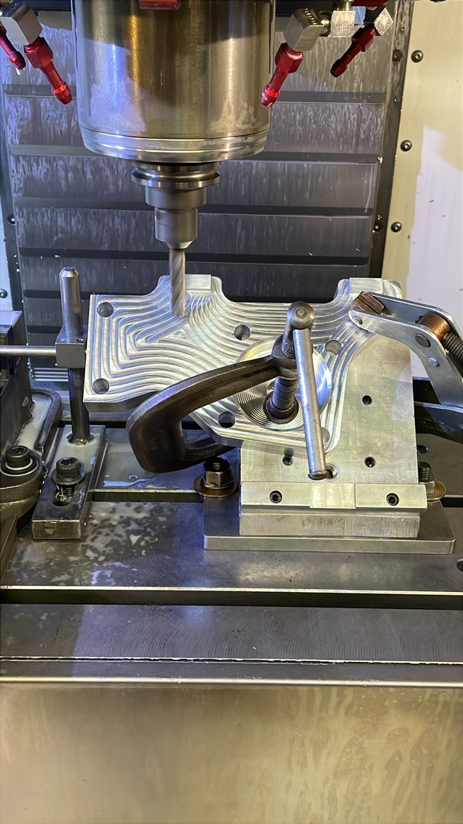 Part being machined in a vertical mill with the tool above